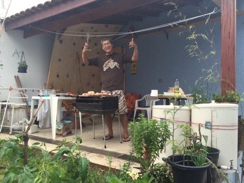 Collaborator giving two thumbs up at an outdoor barbecue