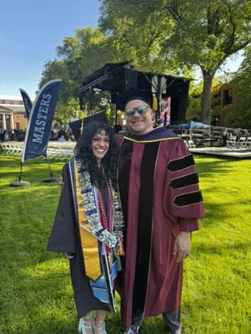 Graduate in cap and gown with Prof. Jeffrey