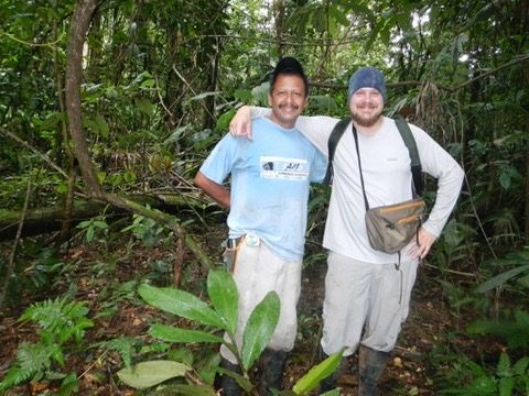 Two researchers smiling in the rainforest