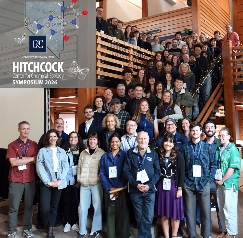 Group photo of about seventy symposium participants on a wooden staircase, with the Hitchcock Center Symposium 2026 logo