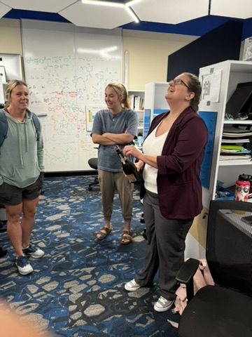 Three colleagues laughing in the lab office