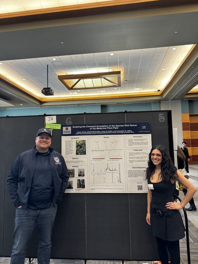 Student and Prof. Jeffrey beside a research poster